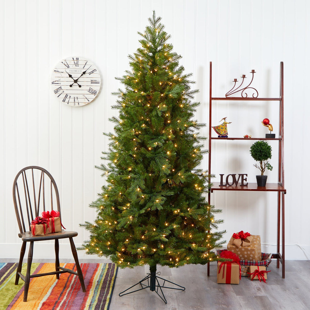 a christmas tree with lights and chairs in a room