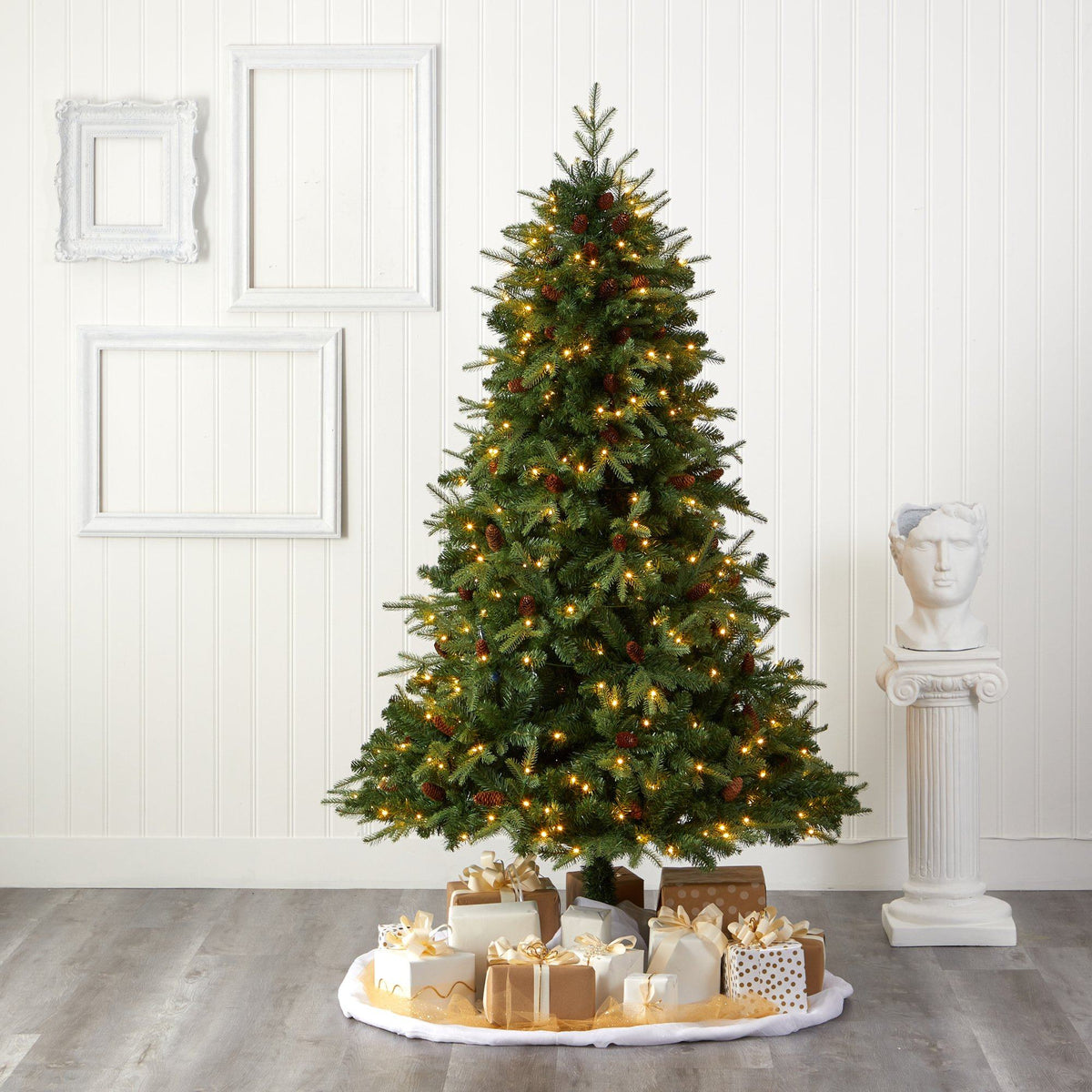 a christmas tree with presents on a white floor