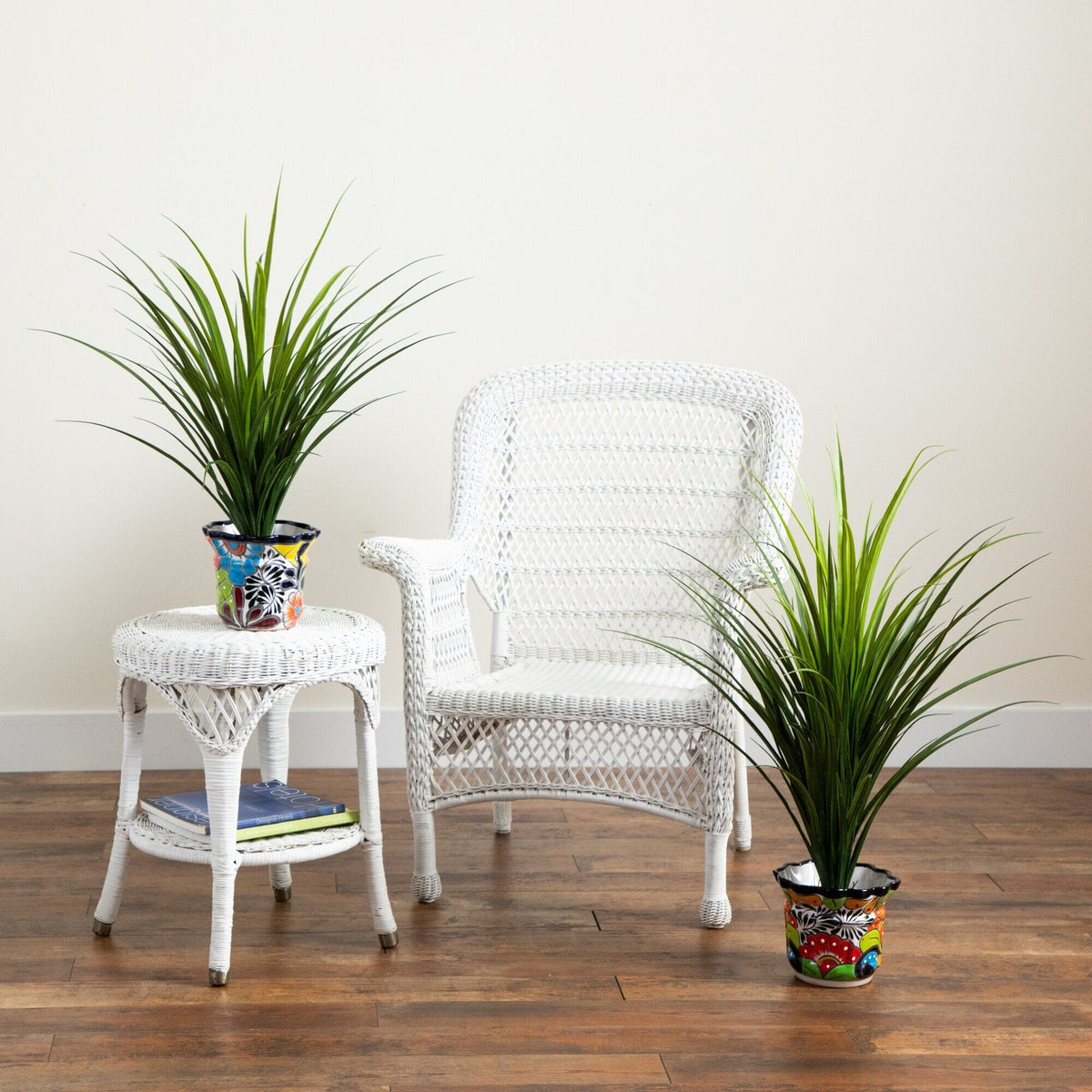 a white chair and two potted plants