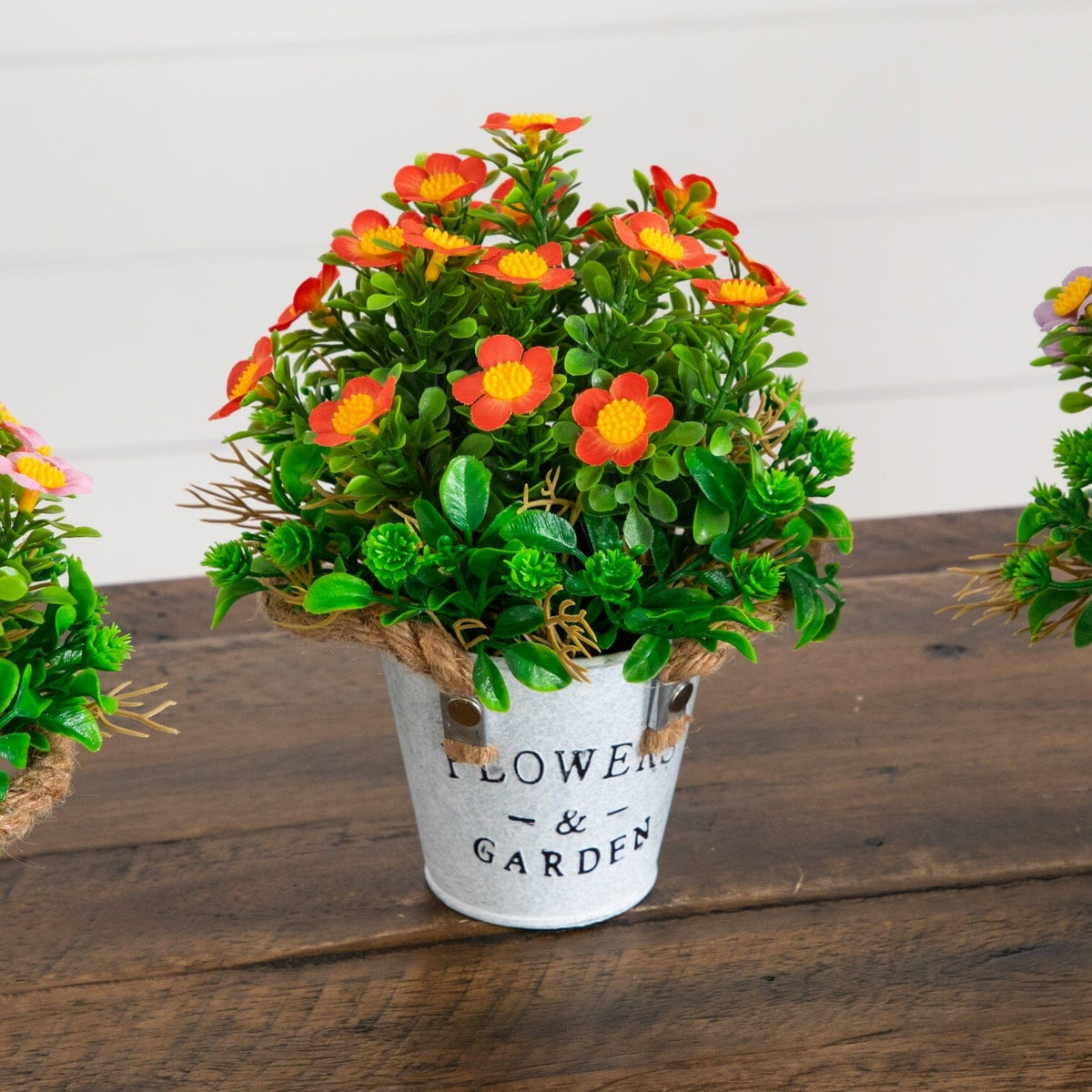 a group of artificial flowers in a pot