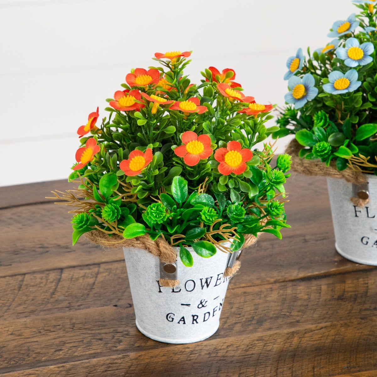 a group of artificial flowers in a pot