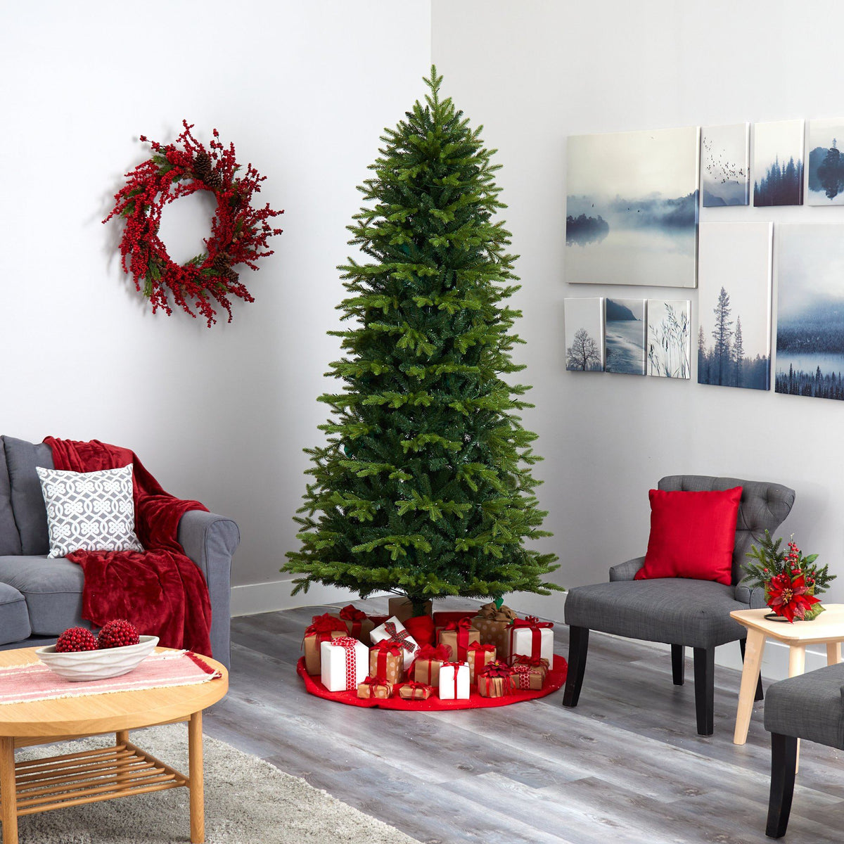 a christmas tree in a room with a couch and a wreath