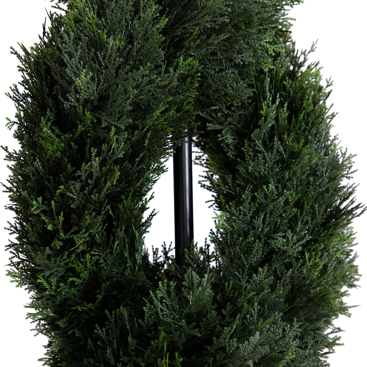 a green wreath with a black pole