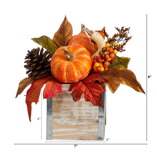 a small pumpkins and leaves in a wooden box