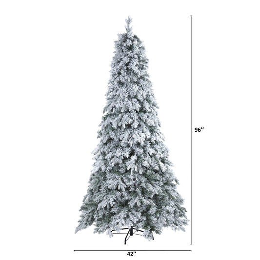 a tall christmas tree with snow on it