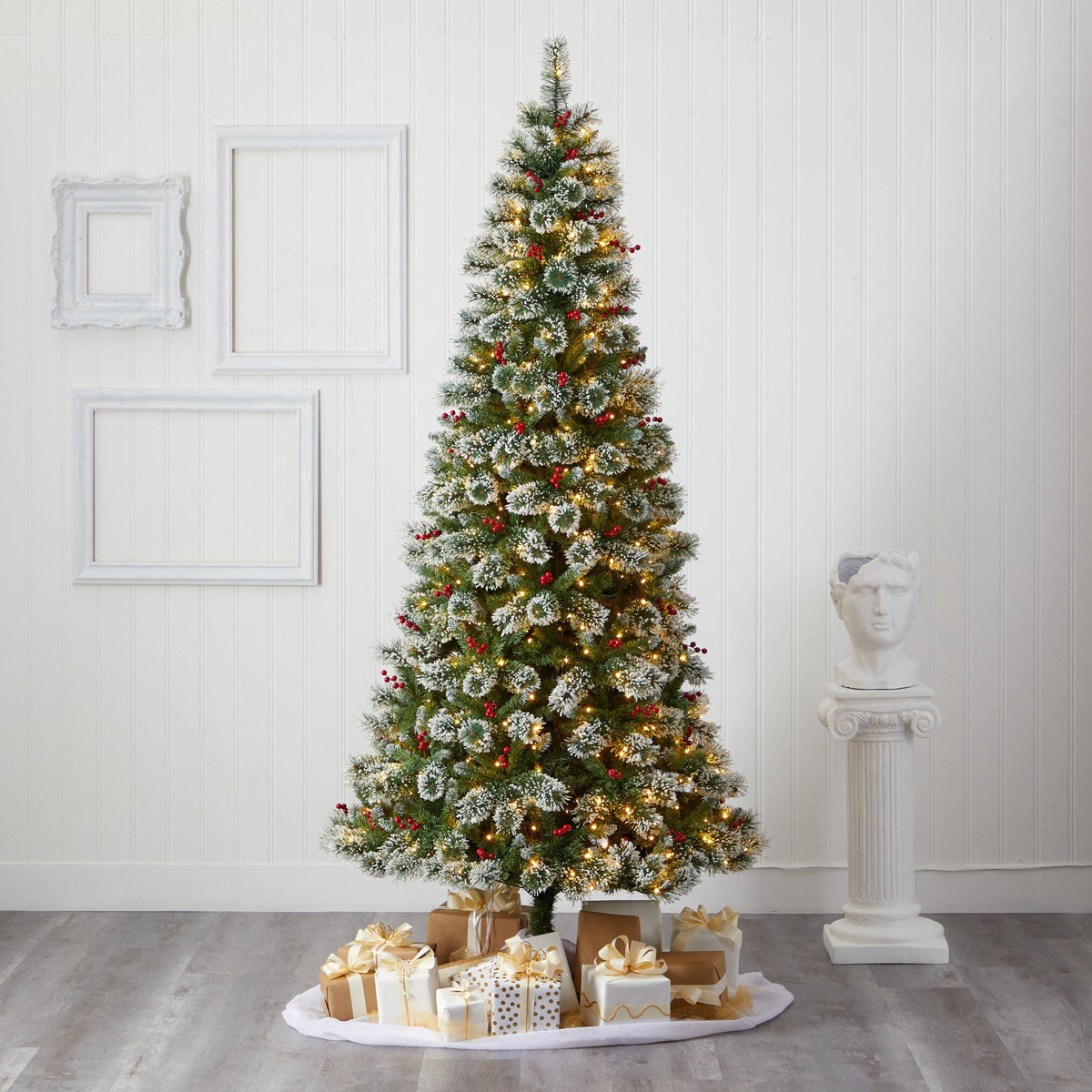 a christmas tree with presents on a white surface