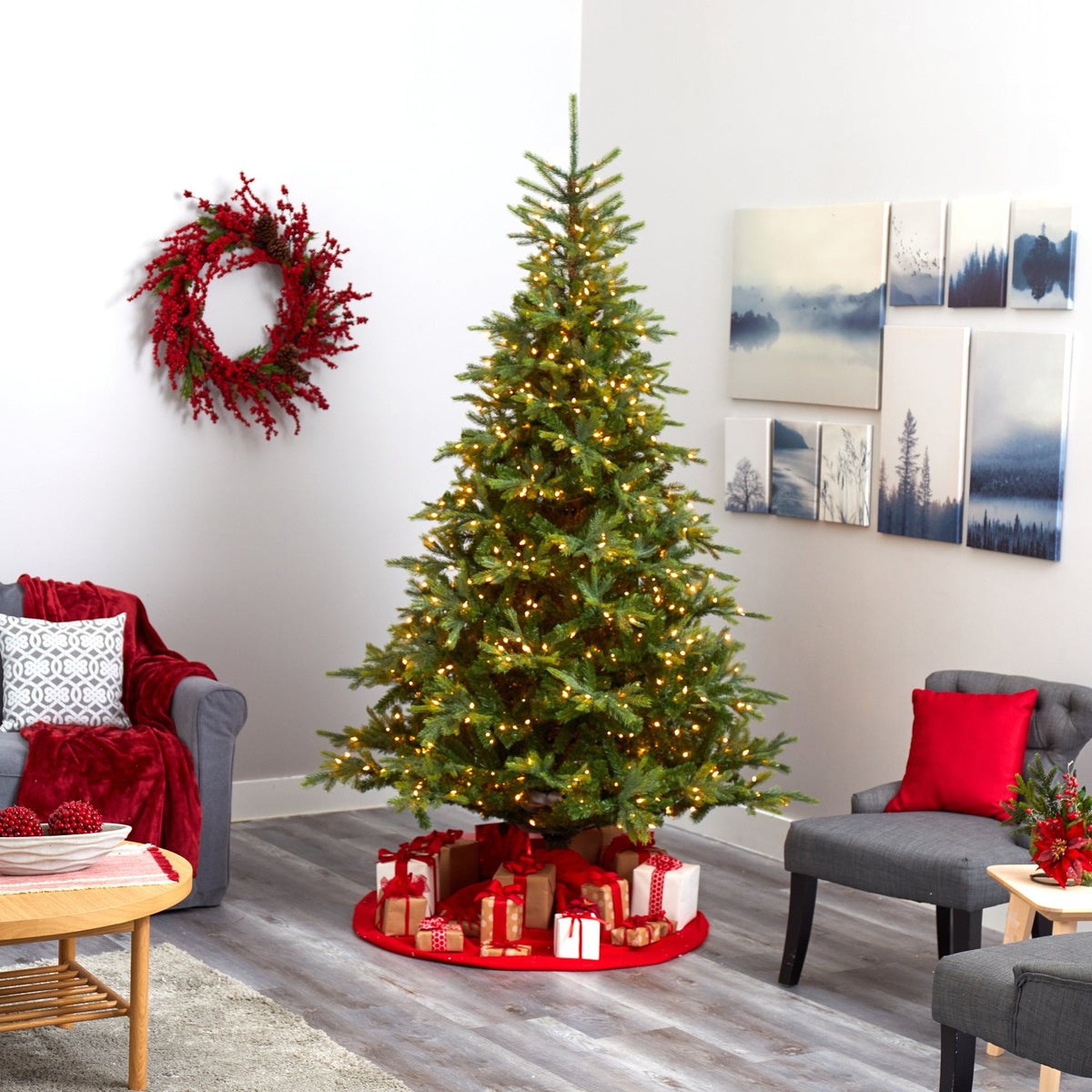 a christmas tree in a room with a couch and a wreath