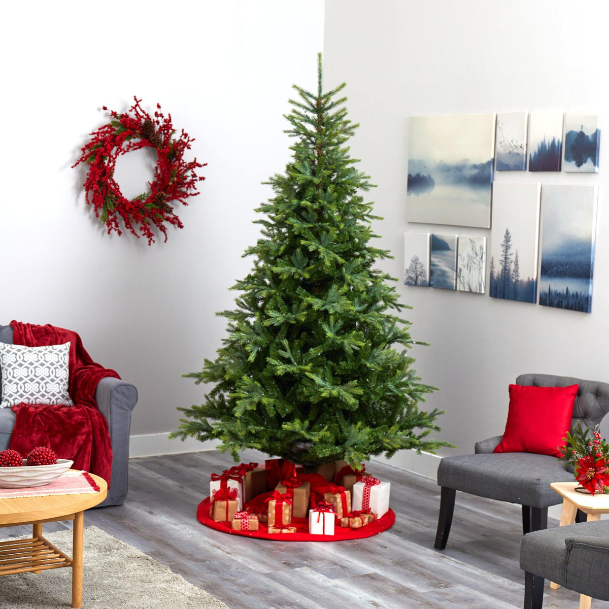 a christmas tree in a room with a couch and a wreath