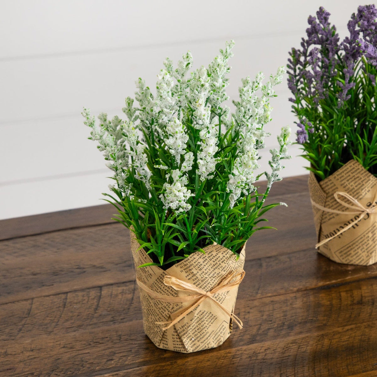 a group of fake flowers in paper pots