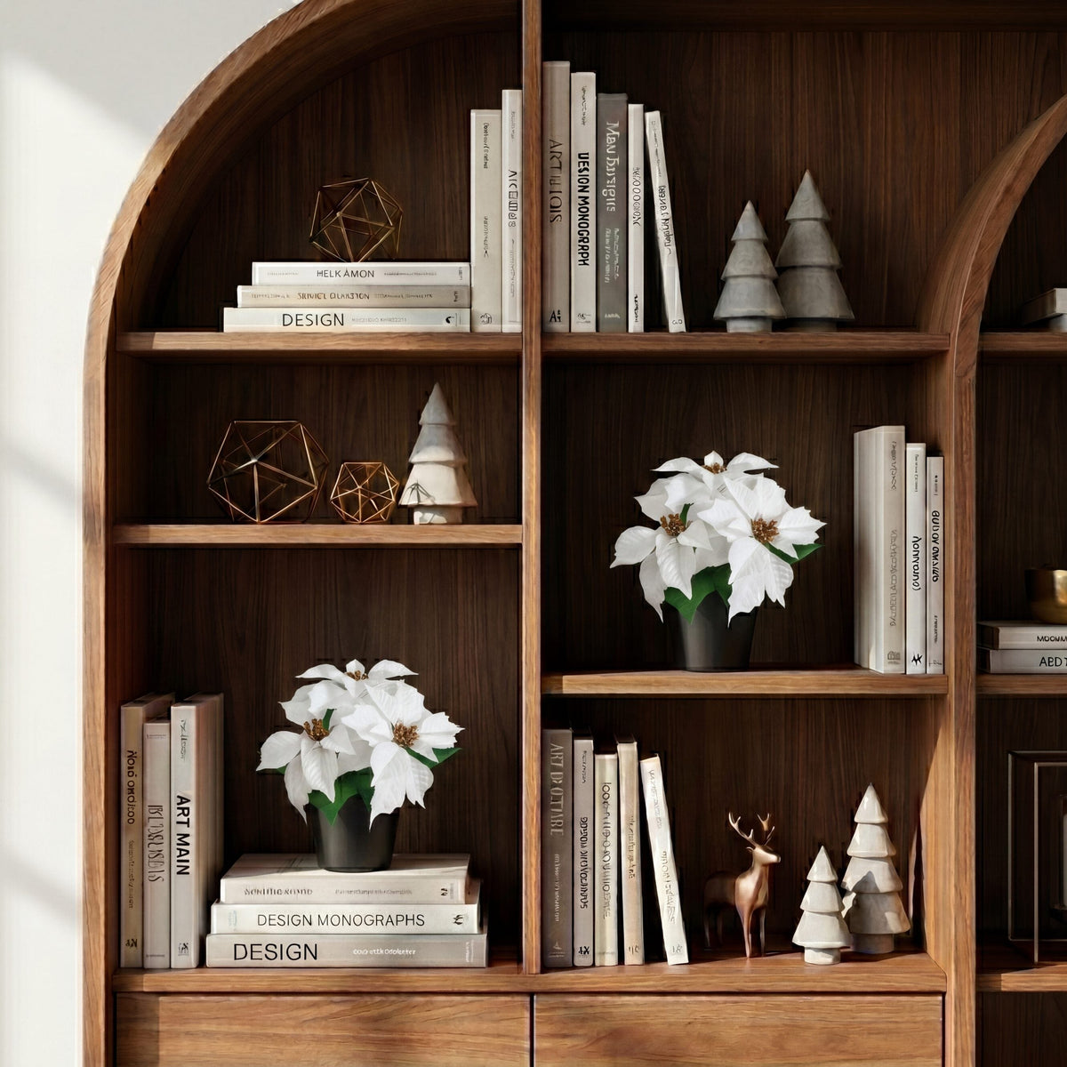 a shelf with books and flowers
