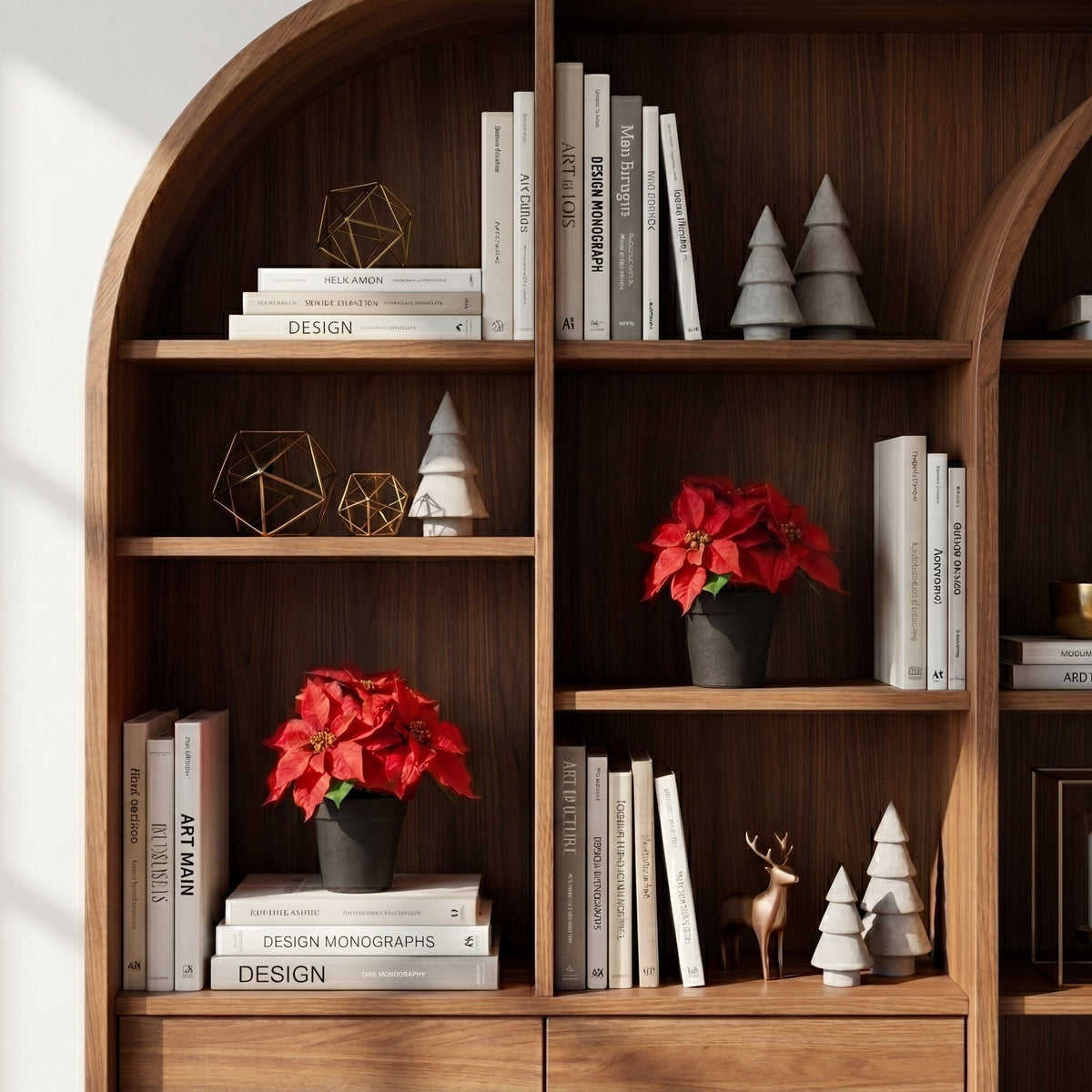 a shelf with books and red flowers