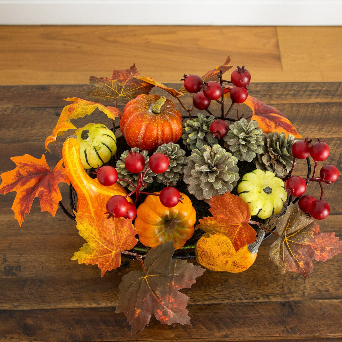 a bowl of autumn leaves and pumpkins