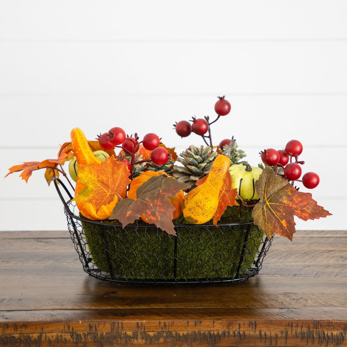 a basket of fake leaves and berries