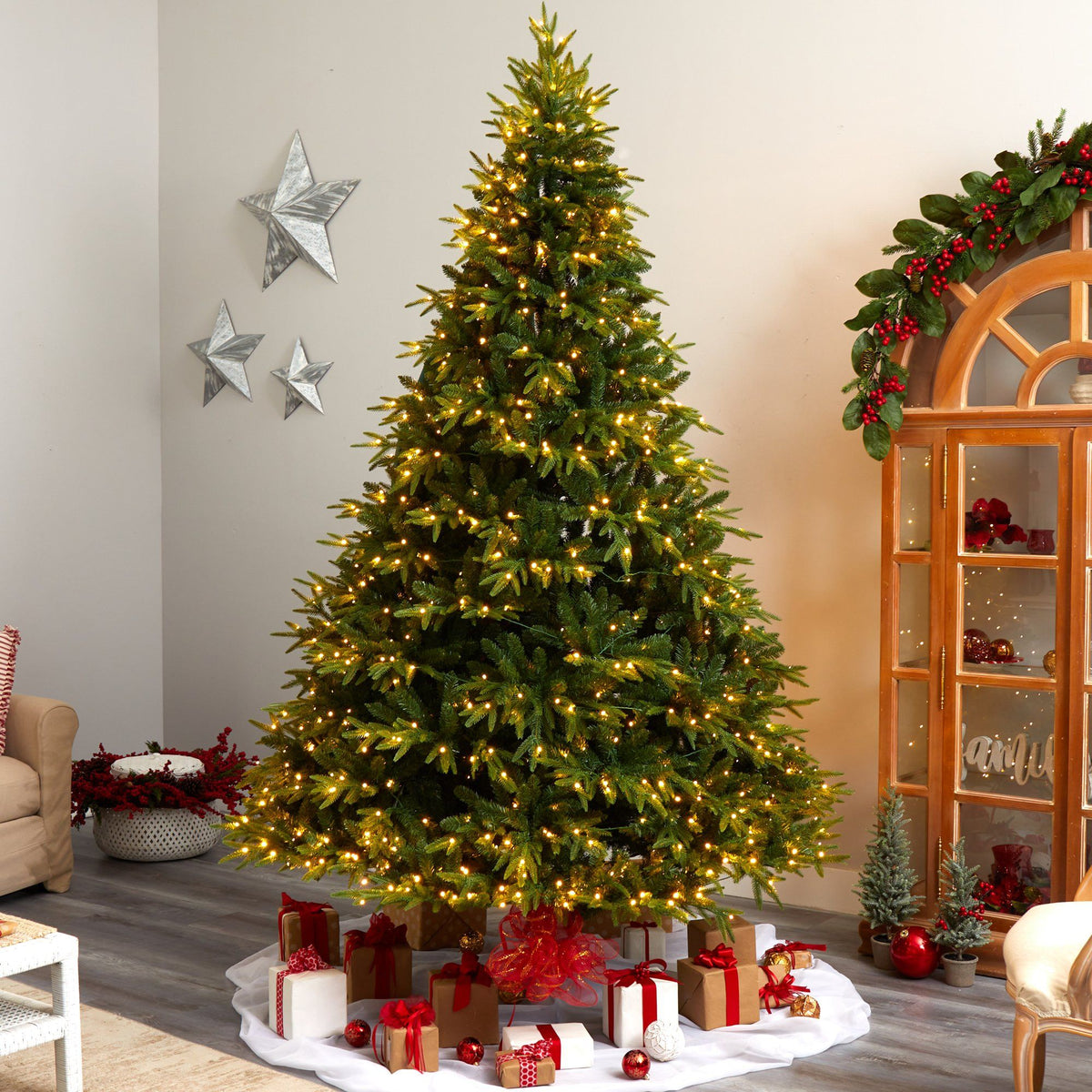 a christmas tree with lights and presents in a room