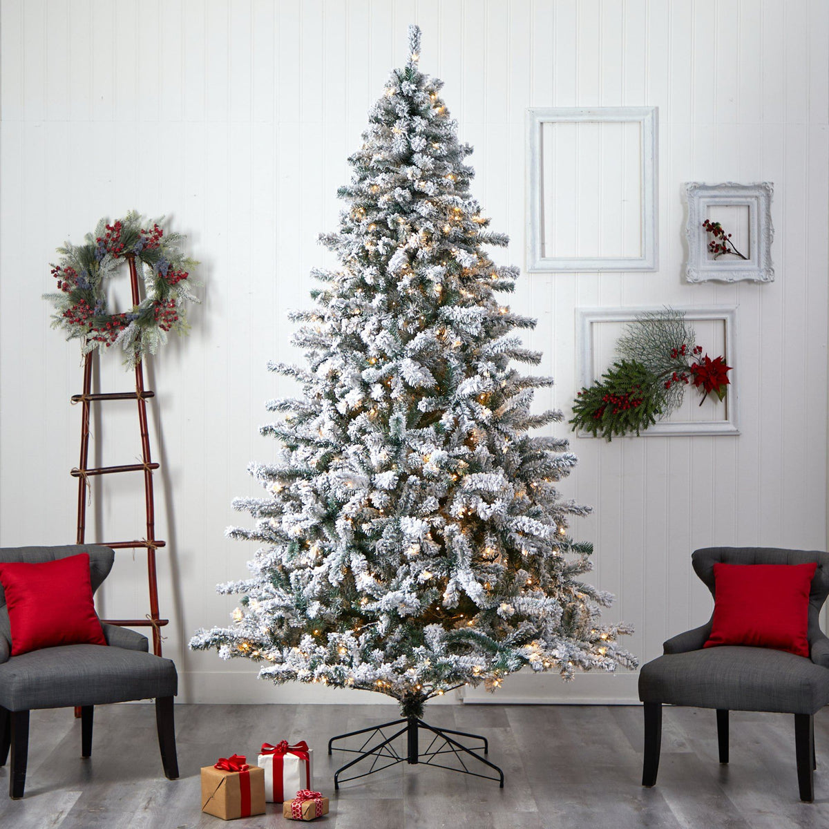 a christmas tree in a room with chairs and a wreath