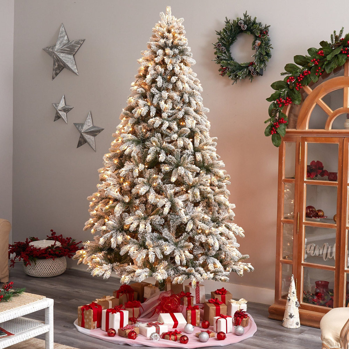 a christmas tree with presents in a room