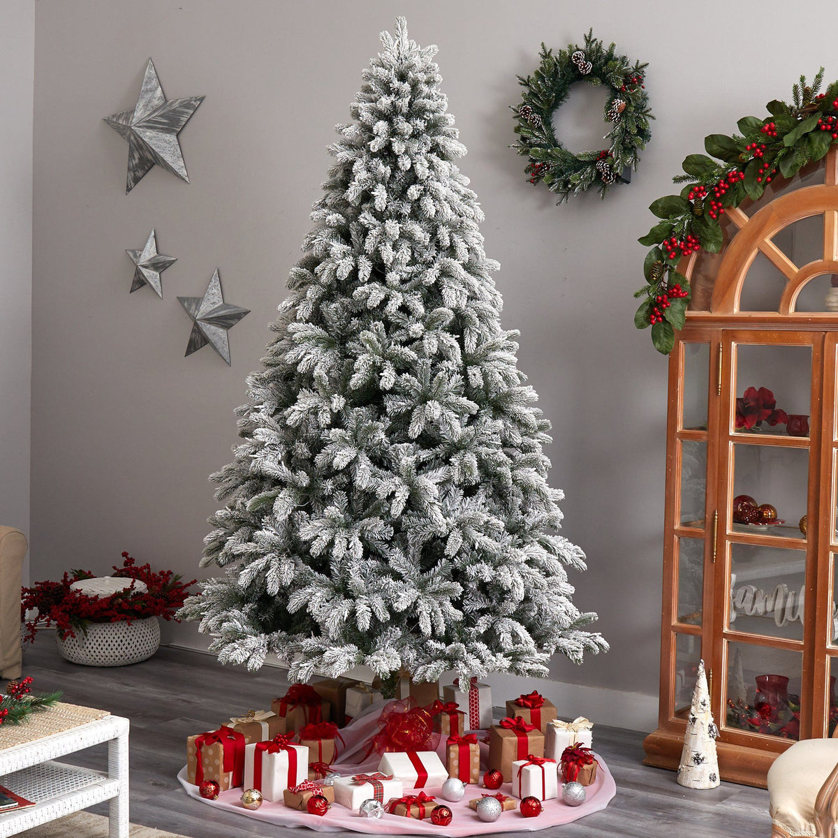 a christmas tree with presents on a pink circle