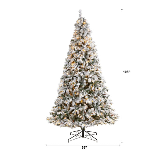 a tall christmas tree with lights and snow