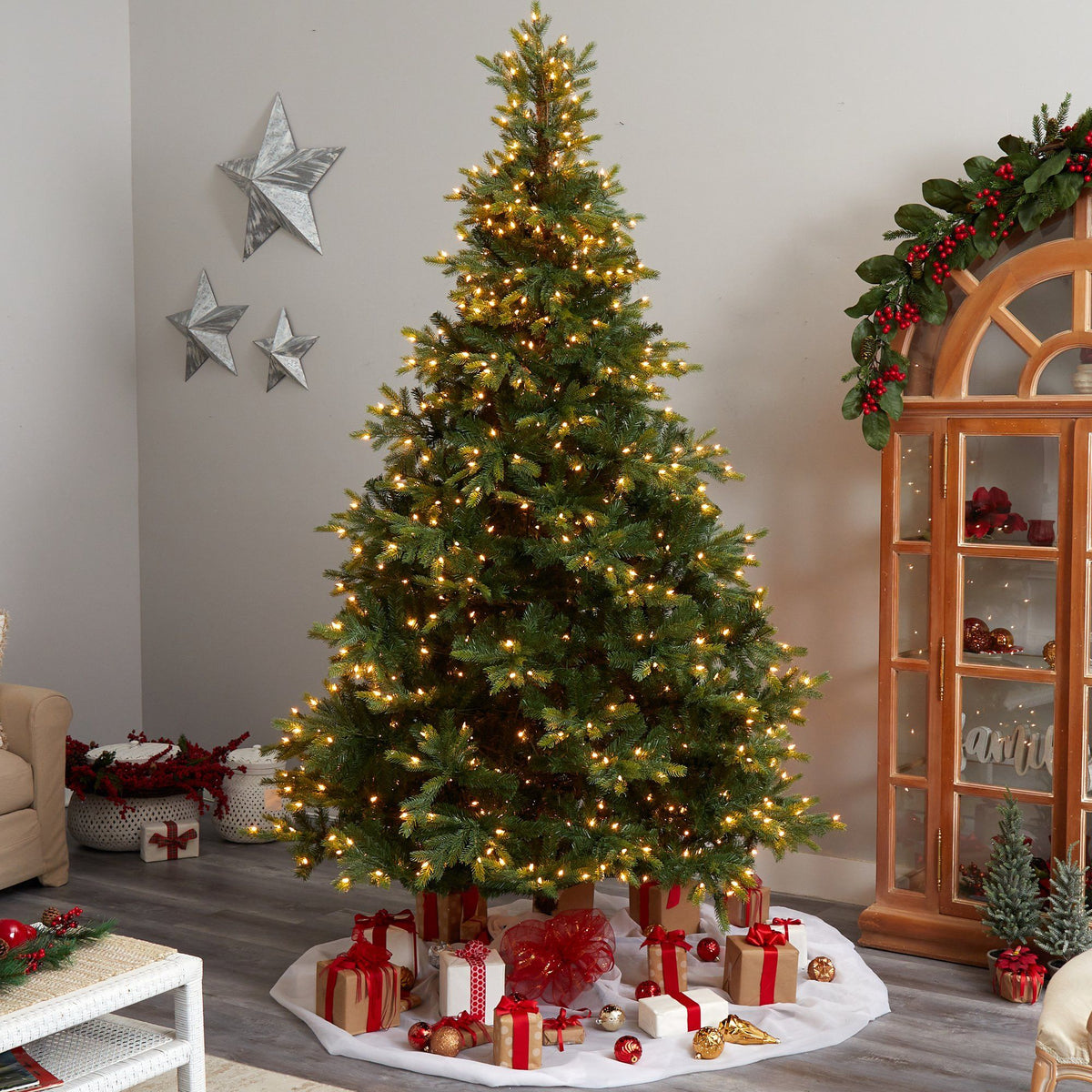 a christmas tree with presents in a room