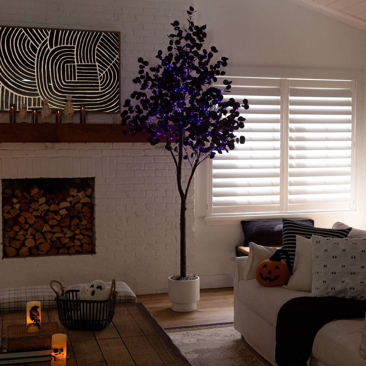 a living room with a tree and a fireplace