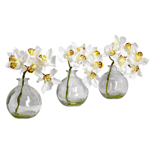 a group of white flowers in glass vases
