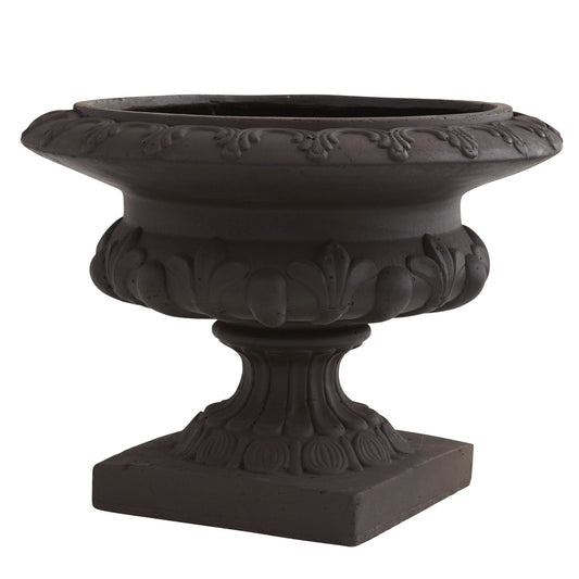 a black stone planter with a white background