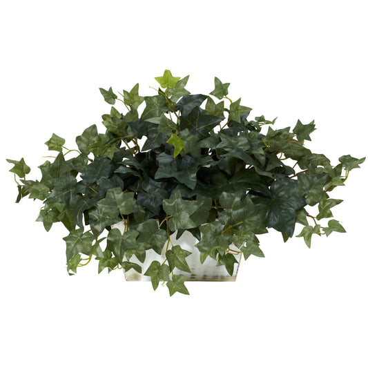 a green plant in a white pot
