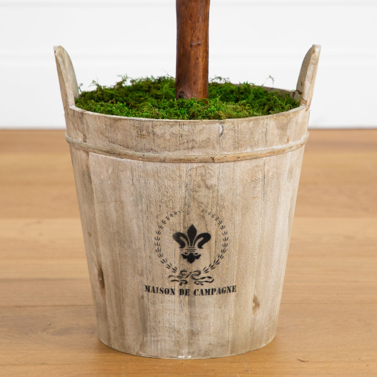a wooden bucket with moss