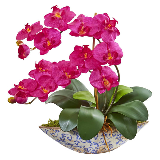 a pink flowers in a blue and white bowl