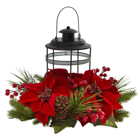 a lantern with red flowers and pine cones