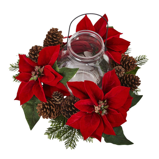 a glass jar with red flowers and pine cones