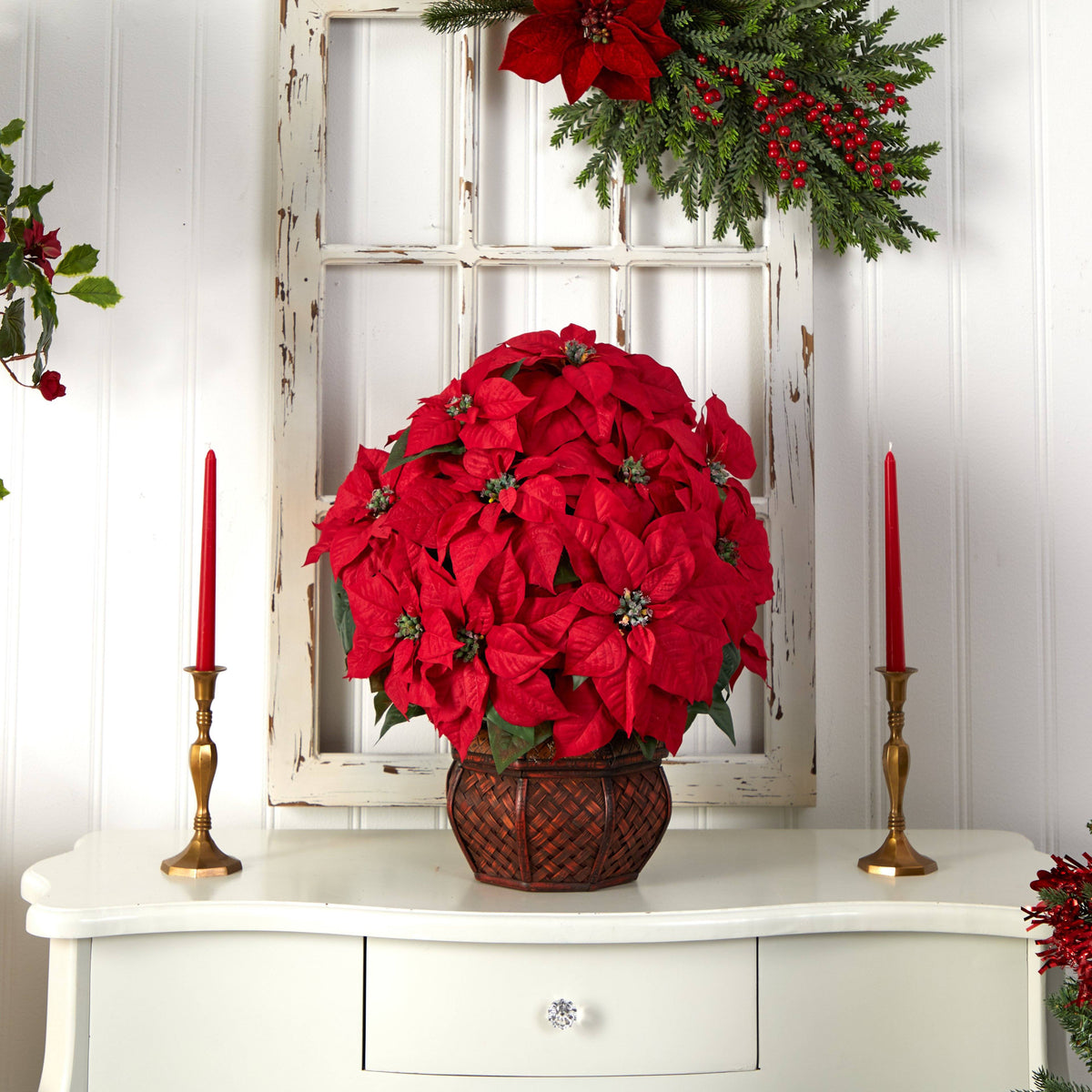 a red poinsettia plant on a dresser
