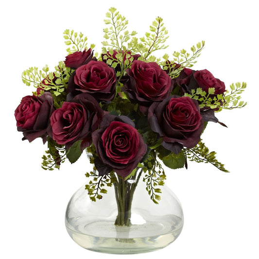 a vase of flowers with green leaves