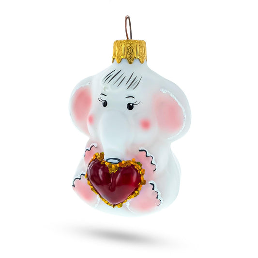 a white elephant ornament with a red heart
