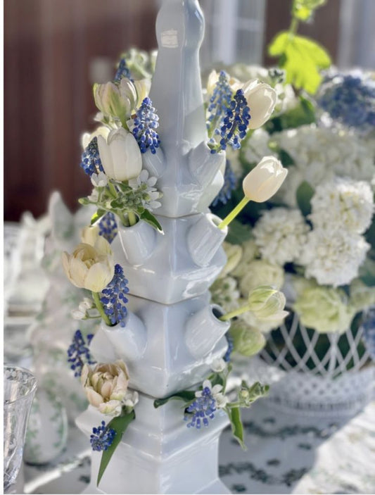 a white vase with flowers