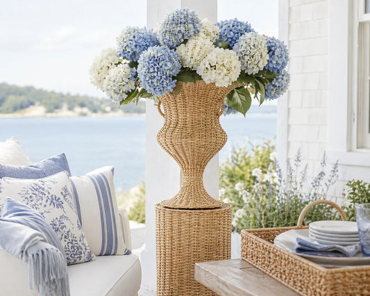 a vase of flowers in front of a white and blue couch