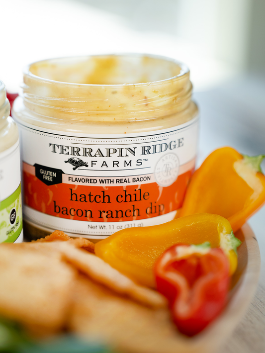 a plate of food with a jar of dip