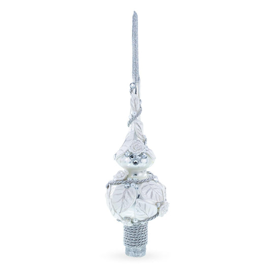 a white and silver christmas tree topper