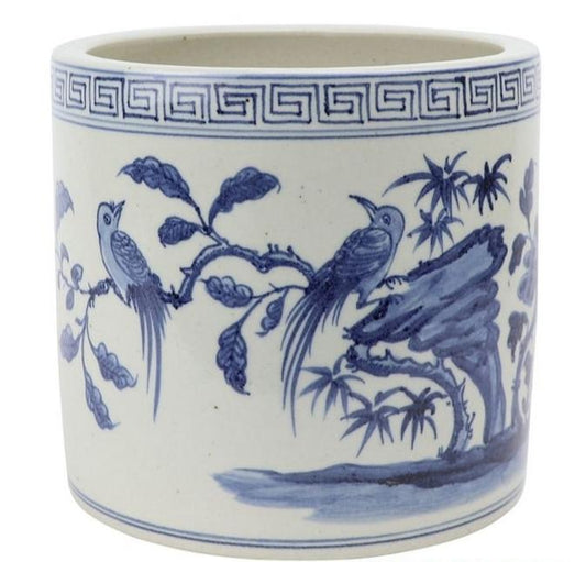 a white and blue painted vase