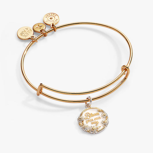 a gold bracelet with a charm