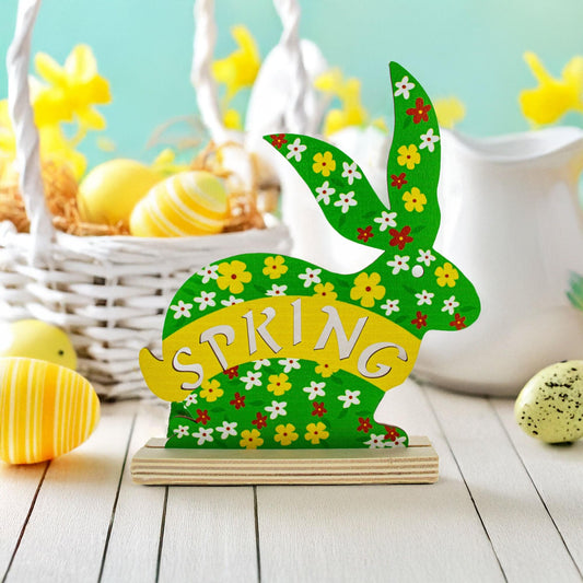 a green bunny with flowers and a basket of eggs