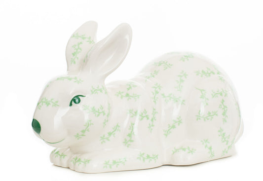 a white rabbit with green designs