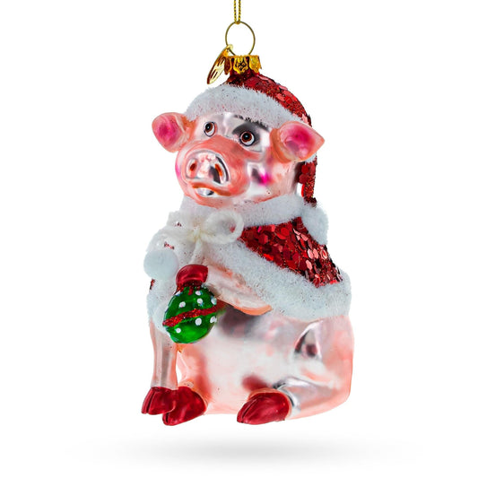 a pink pig ornament with a red hat and white fur