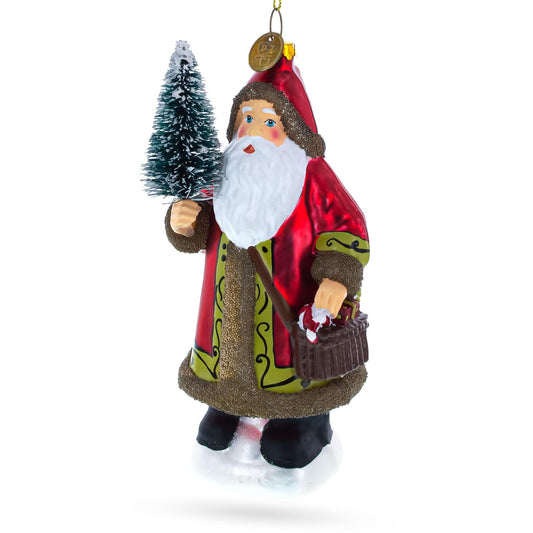 a christmas ornament with a santa claus holding a tree