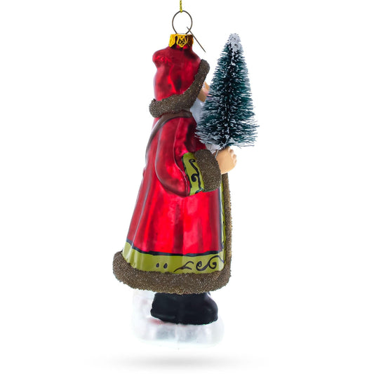 a christmas ornament with a red coat and a small tree