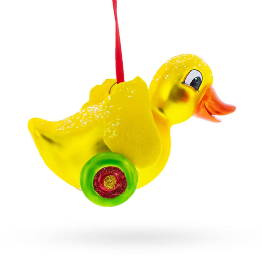 a yellow duck on wheels ornament
