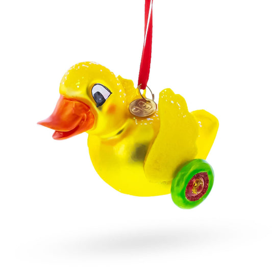 a yellow duck with a coin on a red ribbon
