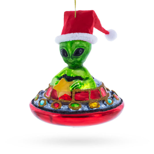 a green alien with a red hat and a red object with a star