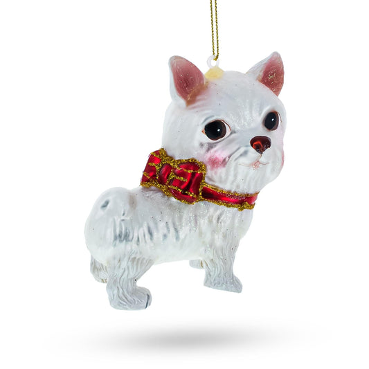 a white dog ornament with a red bow