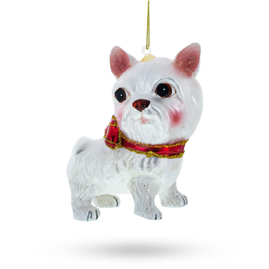 a white dog ornament with a red scarf